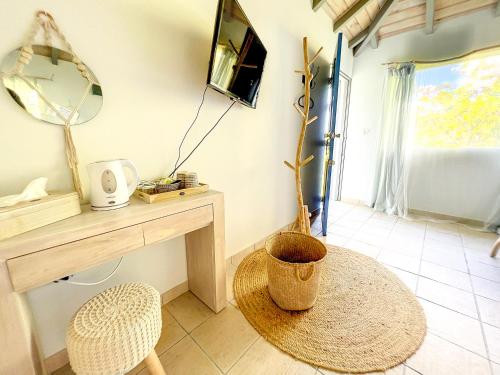 a room with a table and a chair and a mirror at Aquamarine, private room in Villa Casa Blue pool sea view in Koolbaai