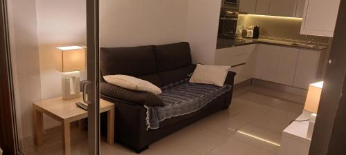 a small living room with a couch and a table at Apartamento Playa in Playa del Ingles