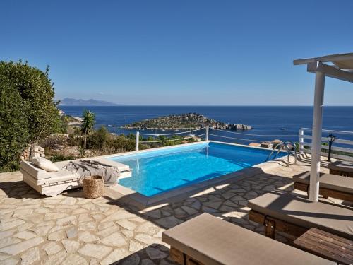 a swimming pool with a view of the ocean at Orfos Villas in Agios Nikolaos
