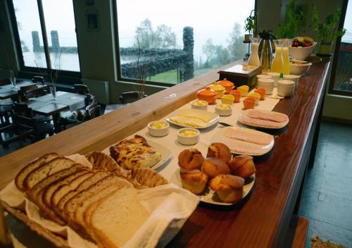a long table with bread and other foods on it at Hotel CasaEstablo by DOT Boutique in Pucón