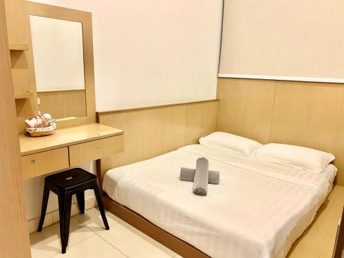 a room with a bed with a cross on it at Deco Home @ Imago The Loft in Kota Kinabalu