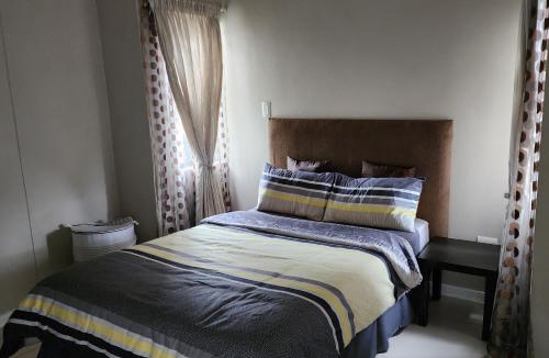 a bedroom with a bed and a window at Urban Park Apartment in Durban
