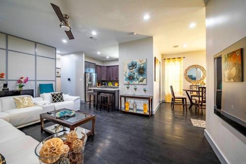 a living room with a white couch and a table at Deluxe House in the Heart of Houston in Houston