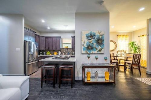 a kitchen and living room with a couch and a table at Deluxe House in the Heart of Houston in Houston