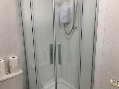 a shower with a glass door in a bathroom at 42 NELSON ST in Largs