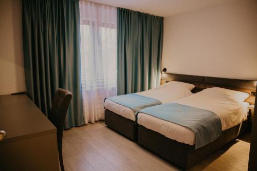 a hotel room with a bed and a window at Saray&App in Sarajevo