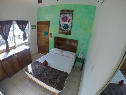 a small bedroom with a bed and a staircase at Kiramar los Peyotes in Rincon de Guayabitos