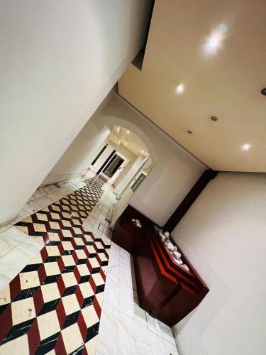 an overhead view of a hallway with a checkered floor at Crops City Stay Apartment 14 in Trieste