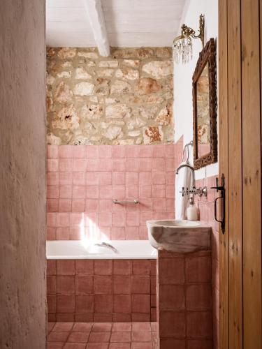 a bathroom with a bath tub and a sink at Orfos Villas in Agios Nikolaos