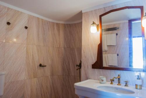 a bathroom with a sink and a mirror at Villa Celestina, Great for Privacy and Seclusion in Chrisopigi