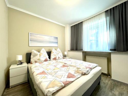 a bedroom with a large bed and a window at Pension Maier in Villach