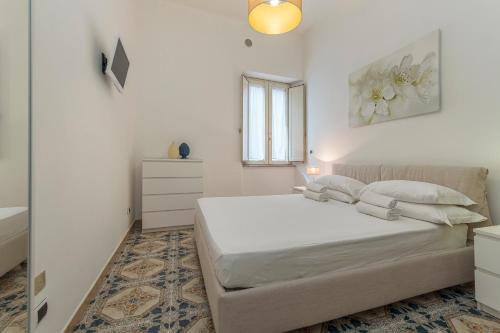 a white bedroom with a bed and a window at ELEGANT APARTMENT IN TAORMINA in Taormina