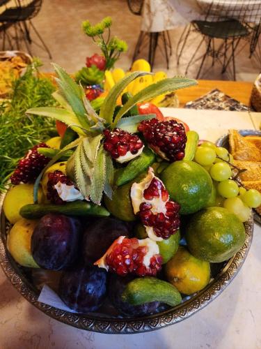 a bowl of fruits and vegetables on a table at Seedi Yousef Hostel & Cafe in Nazareth