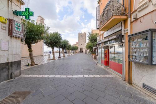 an empty street in a town with a building at ELEGANT APARTMENT IN TAORMINA in Taormina