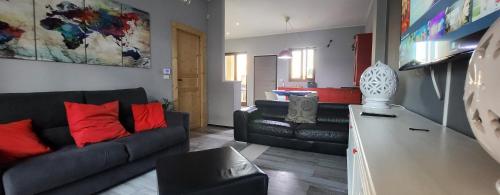 a living room with a black couch and red pillows at Apartment Simone in Lecce