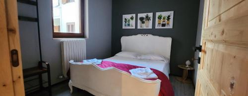 a small bedroom with a white bed and a window at Apartment Simone in Lecce