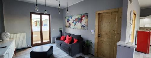 a living room with a couch and a wooden door at Apartment Simone in Lecce
