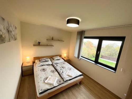 a bedroom with a bed with two lamps and a window at Luxury Villa Rosemary with free garage in Szentendre in Szentendre
