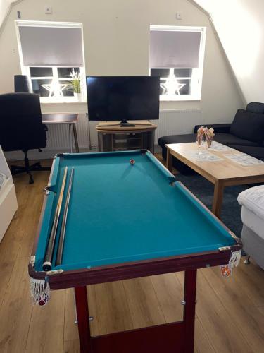 a pool table in the middle of a living room at Glamping Stay with Comfortable Beds and a Beautiful Garden in Kallfors, Stockholm near a Golf Course, Lakes, the Baltic Sea, Forests & Nature in Järna