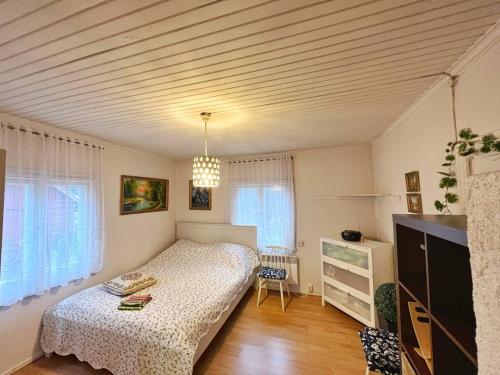 a bedroom with a bed and a dresser in it at Finnish house near the forest in Lappeenranta