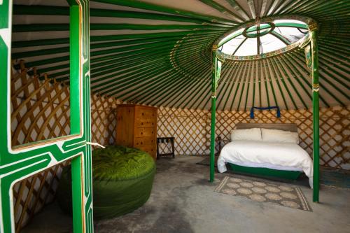 a bedroom with a bed in a yurt at 28 Palms Ranch in Twentynine Palms