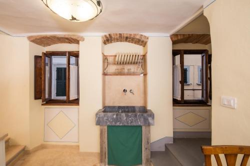 a kitchen with a sink in a room at IBibiena - SUITE CECCO E MEA in Bibbiena