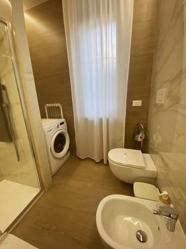 a bathroom with a sink and a toilet and a shower at Cà Sal Holiday Home in Lesina