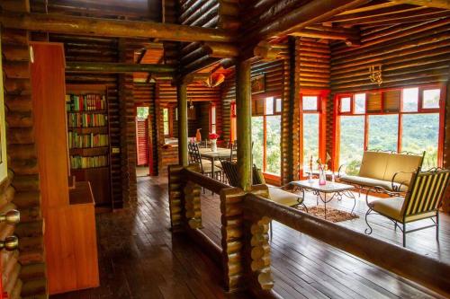 a log cabin with a library and a living room at Eco Cabañas San Lorenzo in La Mesa