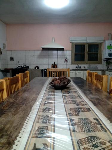a kitchen with a wooden table with a bowl on it at El Viejo Roble in Bragado