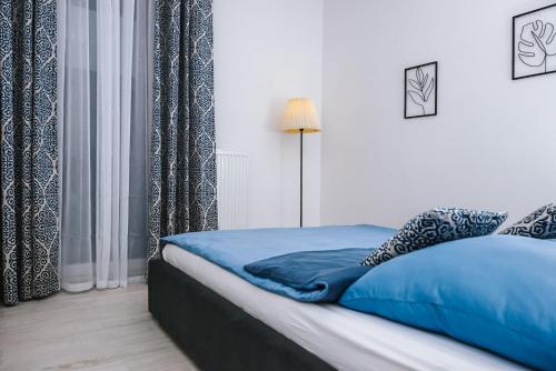 Posteľ alebo postele v izbe v ubytovaní Mazurski Apartament 2