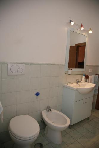 a bathroom with a toilet and a sink at La Terrazza in Tuscania