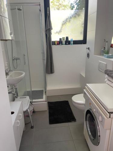 ein Badezimmer mit einem Waschbecken und einer Waschmaschine in der Unterkunft Ferienwohnung Zentral in Kassel in Kassel