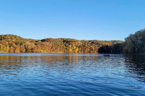 a lake with a boat in the middle of it at Pickwick Lake Home with Screened-In Porch, Dock in Counce
