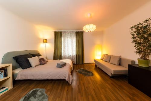 a living room with a bed and a couch at Cosy apartment in great Location in Vienna