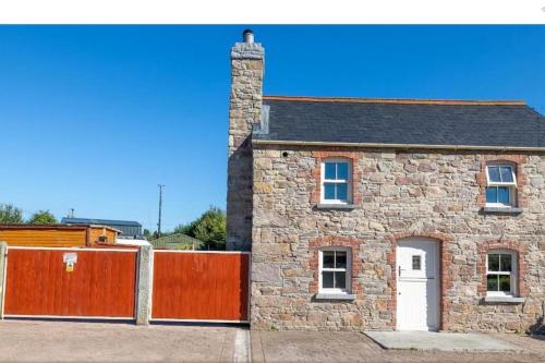 a brick house with a gate and a fence at 2 Bed Sandstone Residence in Newport