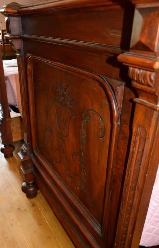 a wooden cabinet with an ornate design on it at b&b CASCINA SORTINA Country House in Ozzano Monferrato