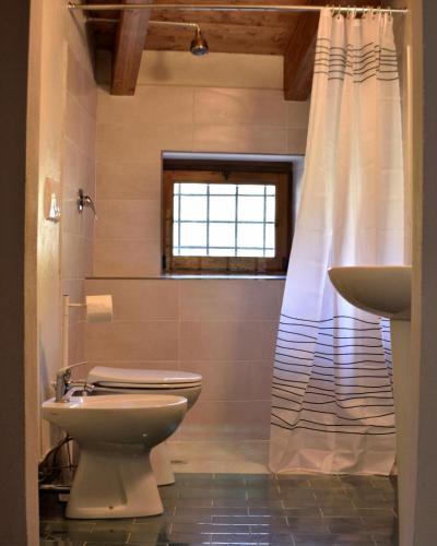 a bathroom with a toilet and a sink at b&b CASCINA SORTINA Country House in Ozzano Monferrato