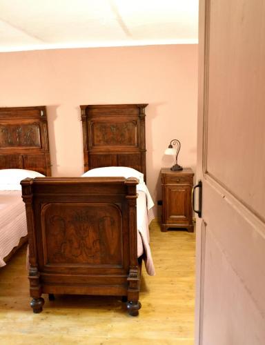 a bedroom with two beds and two night stands at b&b CASCINA SORTINA Country House in Ozzano Monferrato