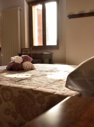 a bedroom with a bed with towels on it at b&b CASCINA SORTINA Country House in Ozzano Monferrato