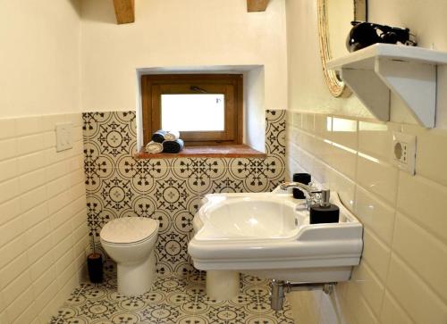 a bathroom with a sink and a toilet at b&b CASCINA SORTINA Country House in Ozzano Monferrato