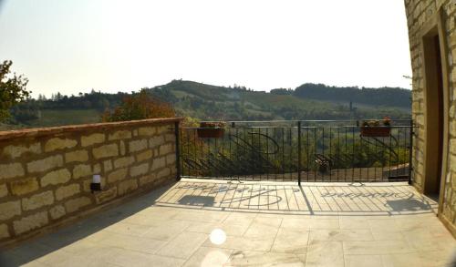 a patio with a fence and a stone wall at b&b CASCINA SORTINA Country House in Ozzano Monferrato