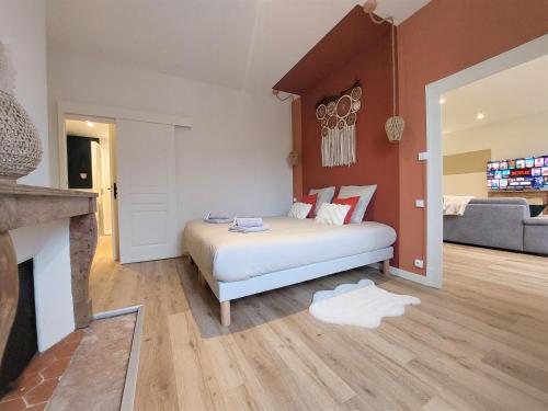 a bedroom with a bed and a living room at Le Cocon d'Anna in Dole