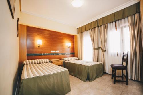 Una cama o camas en una habitación de Gavilanes 2 TOLEDO