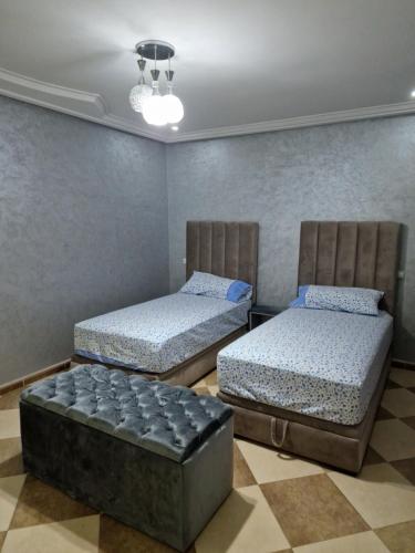 two twin beds in a room with at RESIDENCE LA CORNICH in Nador
