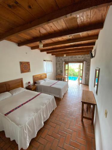 a bedroom with two beds in a room at Hotel Posada La Vereda in Cuetzalán del Progreso