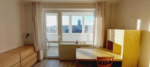 a room with a desk and a large window at Central Apartments View in Gdańsk