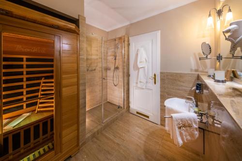 a bathroom with a shower and a sink at La Contessa Castle Hotel in Szilvásvárad