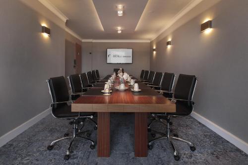a conference room with a long table and chairs at Van der Valk Hotel Melle - Osnabrück in Melle