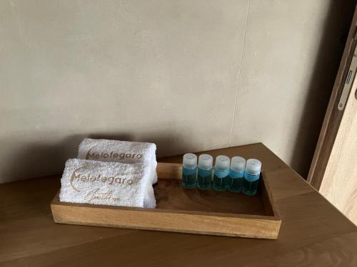 a wooden tray with a group of test tubes on a table at Melofegaro Guesthouse in Palaios Panteleimon