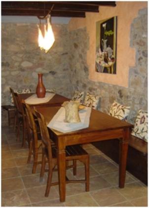 a dining room with a wooden table and chairs at El Pedrís in El Pont de Suert